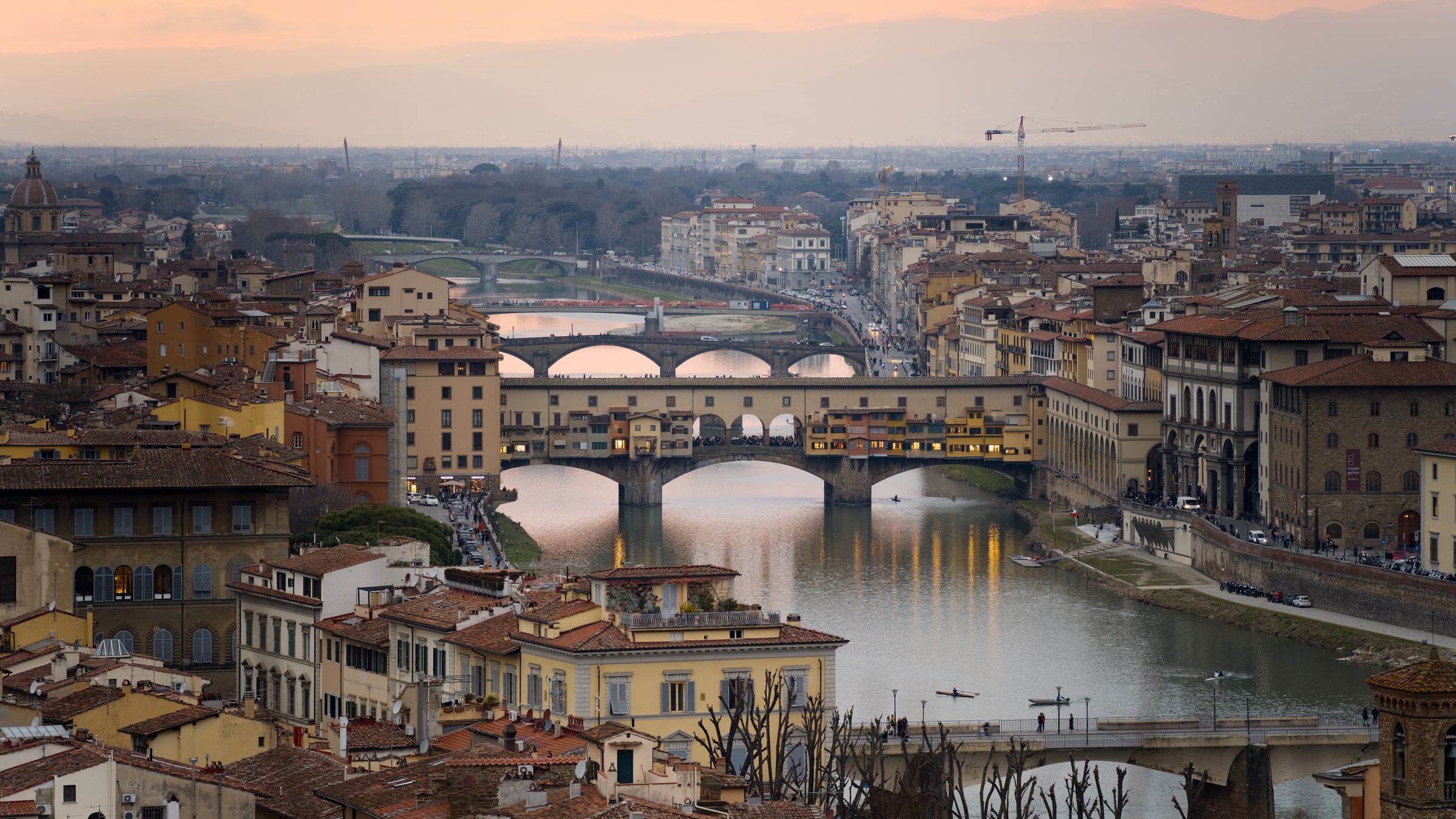 Ponte Vecchio and the Arno in Florence at sunset; a city context photograph, not a museum entrance or a free-admission queue