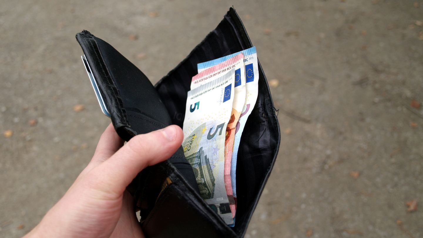 Euro banknotes in an open black wallet