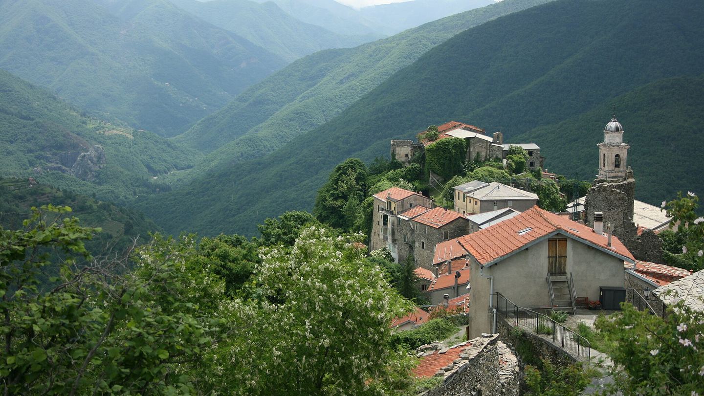 The stone roofs of Triora on a wooded Ligurian ridge