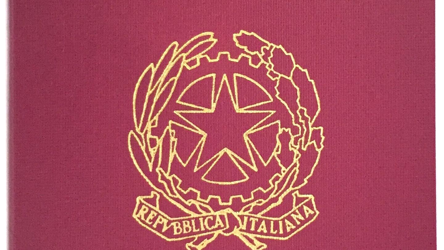 Detail of an Italian biometric passport on a dark surface
